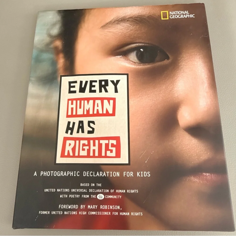 National Geographic Every Human Has Rights Book with Red and Black Accents
